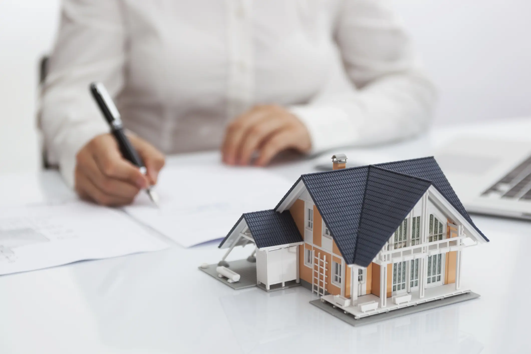 Woman Signing House Purchase Agreement a specialist signing some house documentation and mortgage