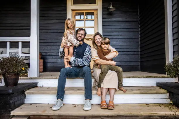 Portrait of young family in front of farmhouse Portrait of young family in front of farmhouse